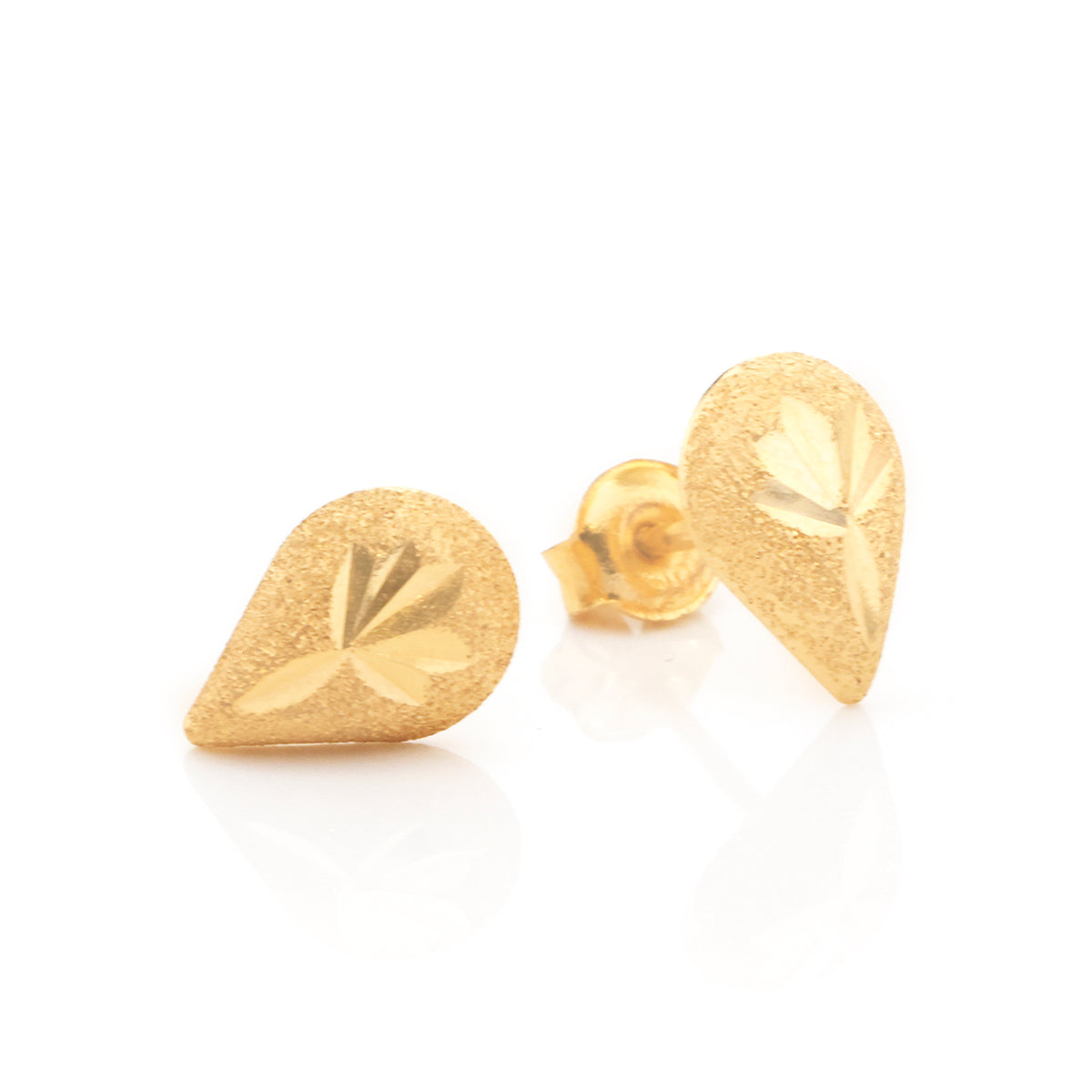 A pair of gold teardrop-shaped stud earrings with a textured matte finish and an engraved leaf design, displayed on a clean white background.