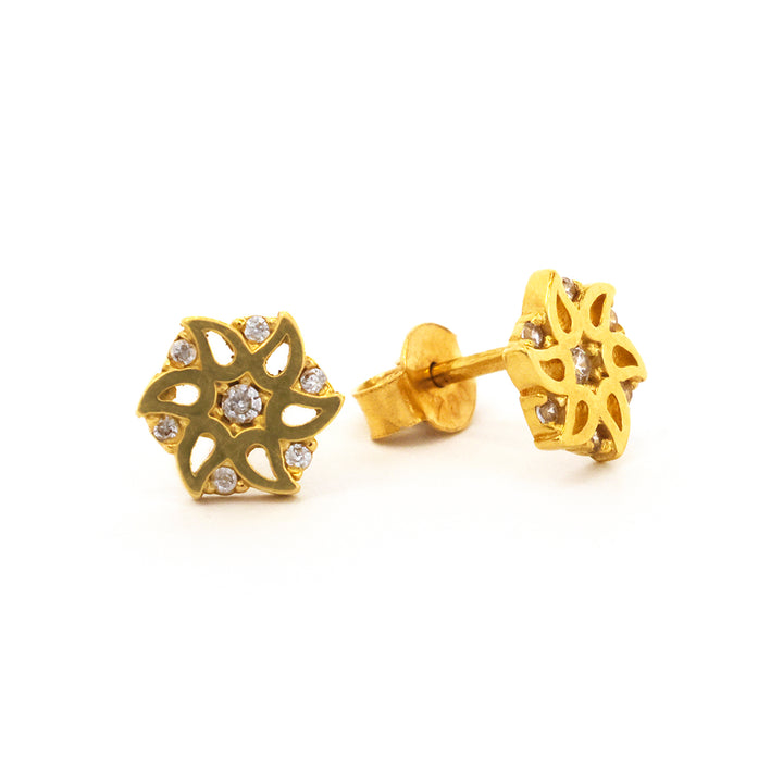 Gold earrings with intricate design on a white background