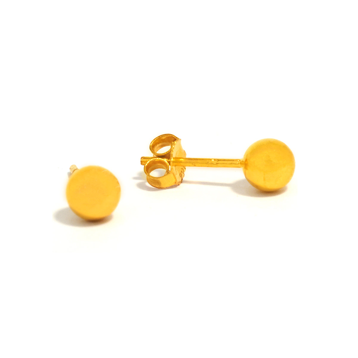 Gold round earrings on a white background