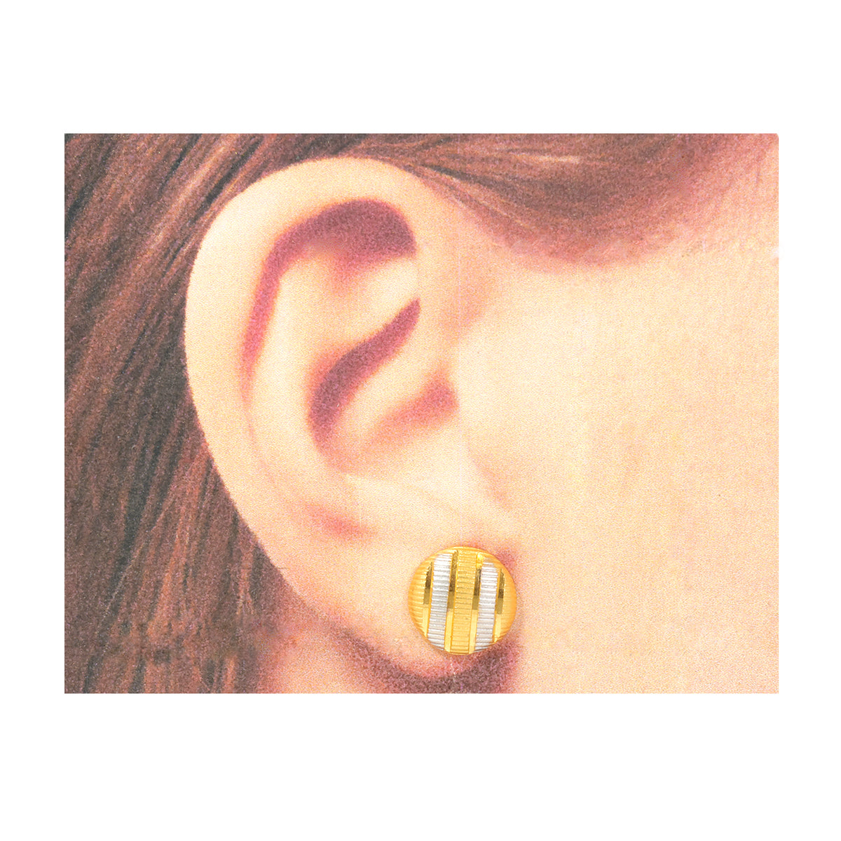 Gold and silver striped earring worn on an ear with a plain background