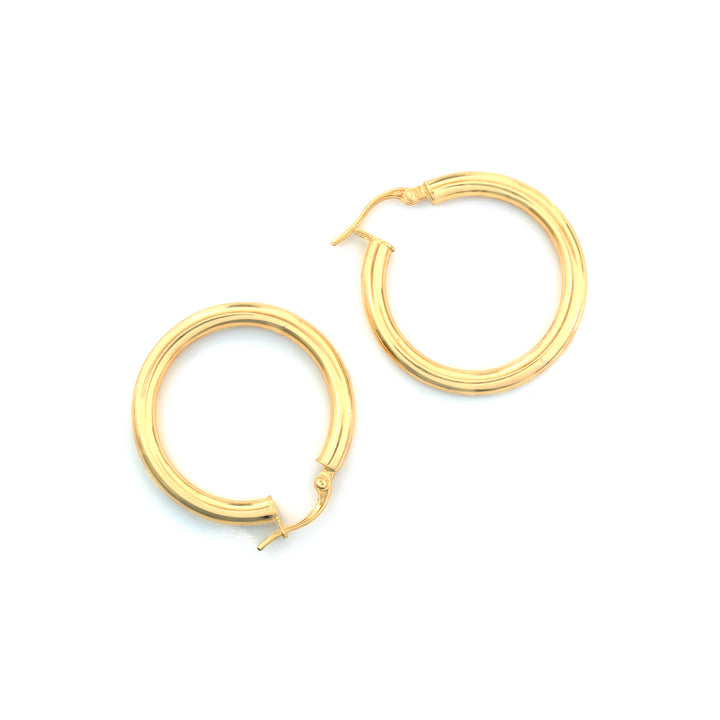 A pair of gold triple-band hoop earrings on a clean white background.