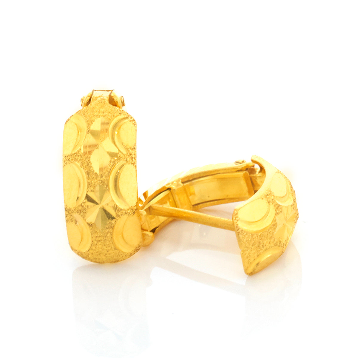 Gold cufflinks with intricate design on a white background
