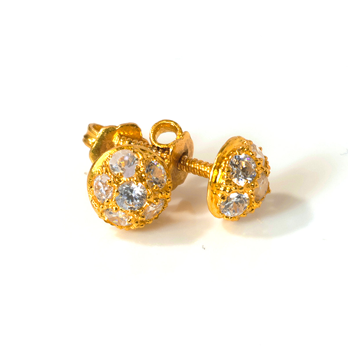 Gold earrings with clear gemstones on a white background