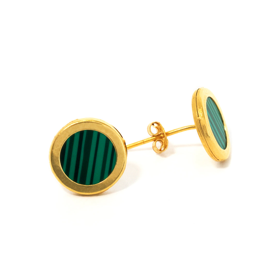 Gold earrings with green circular stones on a white background
