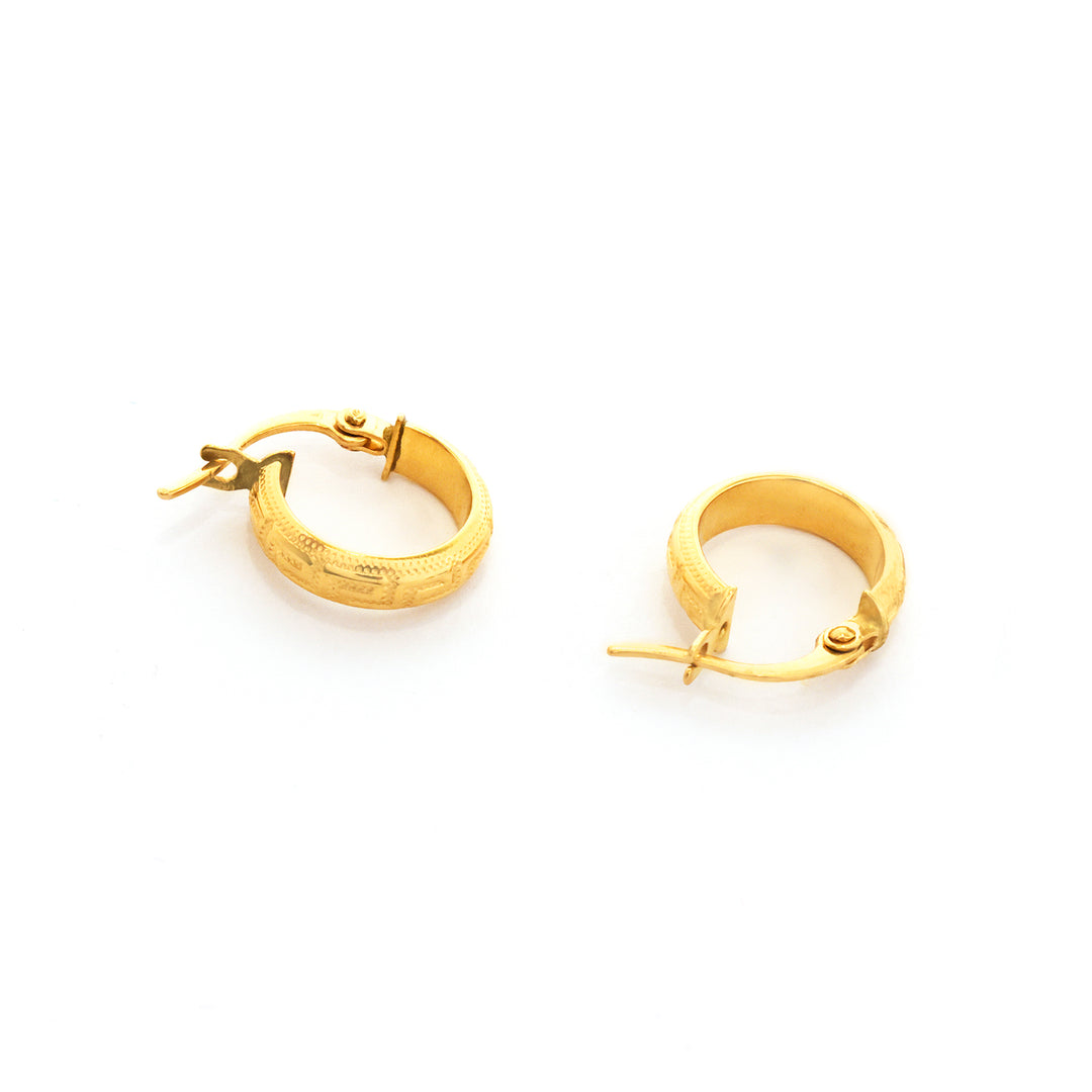 Gold hoop earrings on a white background