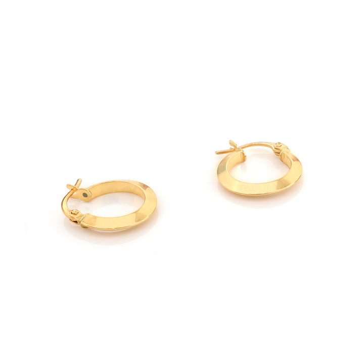 A pair of polished yellow gold huggie hoop earrings on a clean white background.