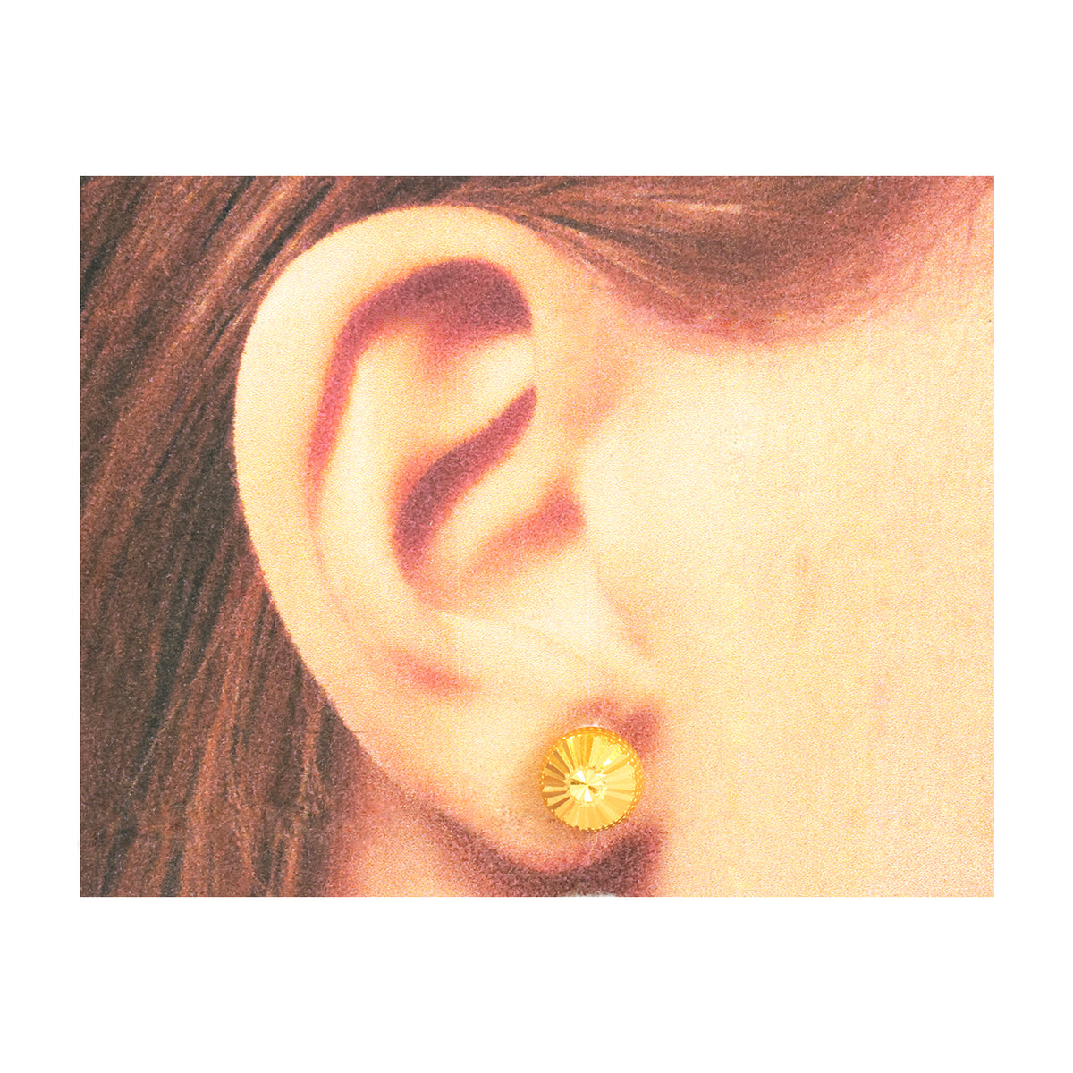 Close-up of an ear wearing a gold earring with hair partially visible.