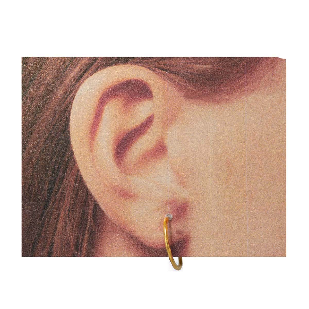 Close-up of an ear wearing a gold hoop earring on a white background
