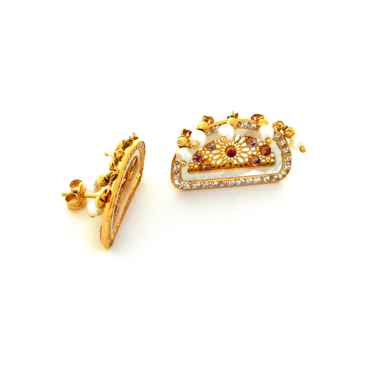 Gold earrings with intricate designs on a white background