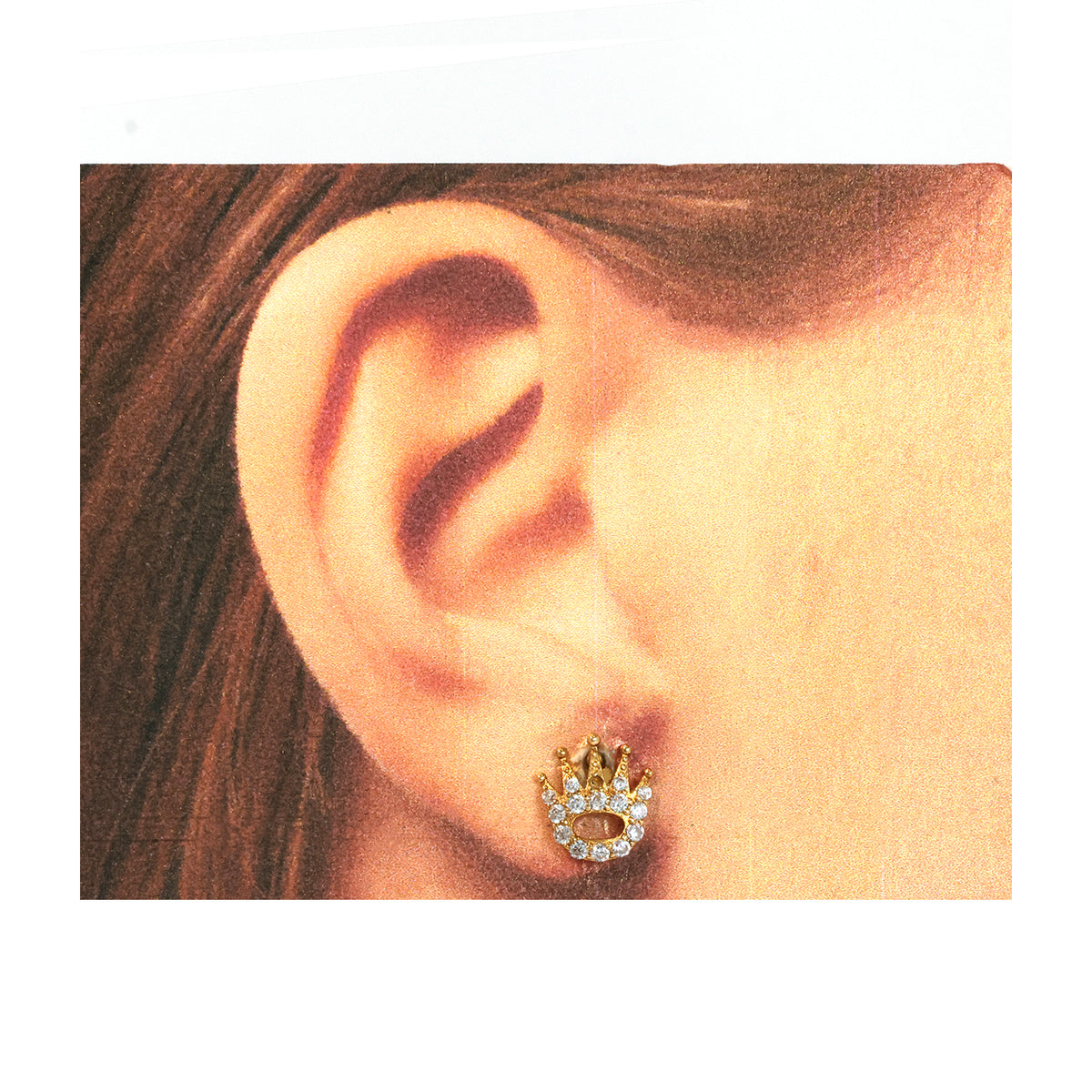 Close-up of an ear wearing a gold and diamond earring.