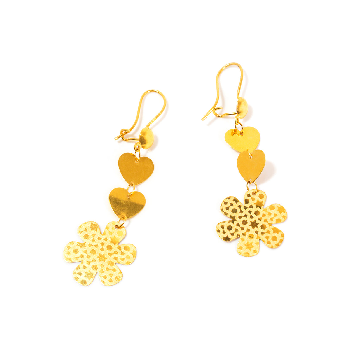 Pair of gold earrings with floral and heart designs on a white background