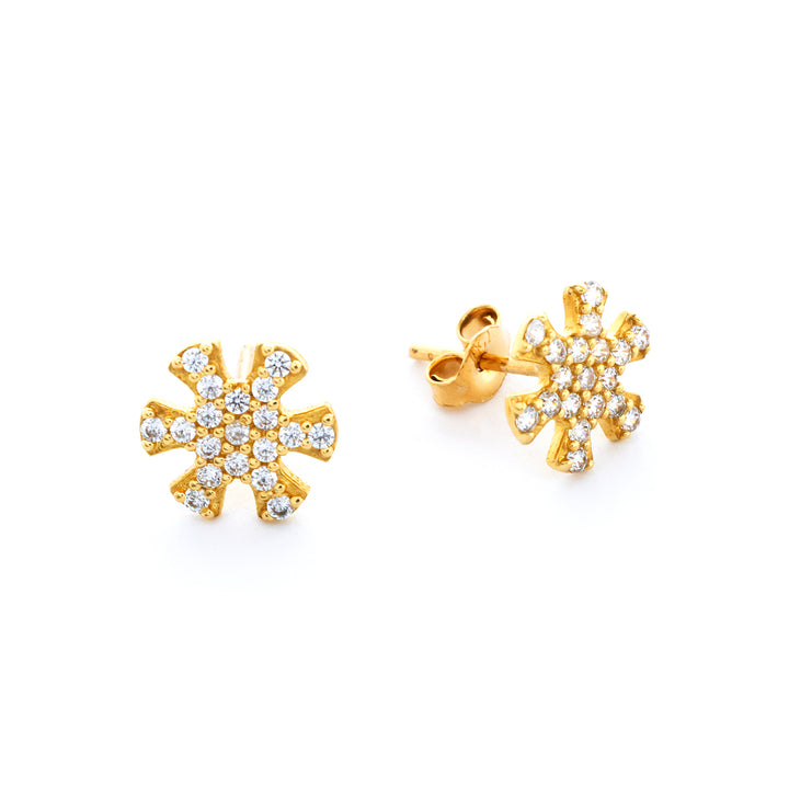 Gold snowflake earrings with clear stones on a white background