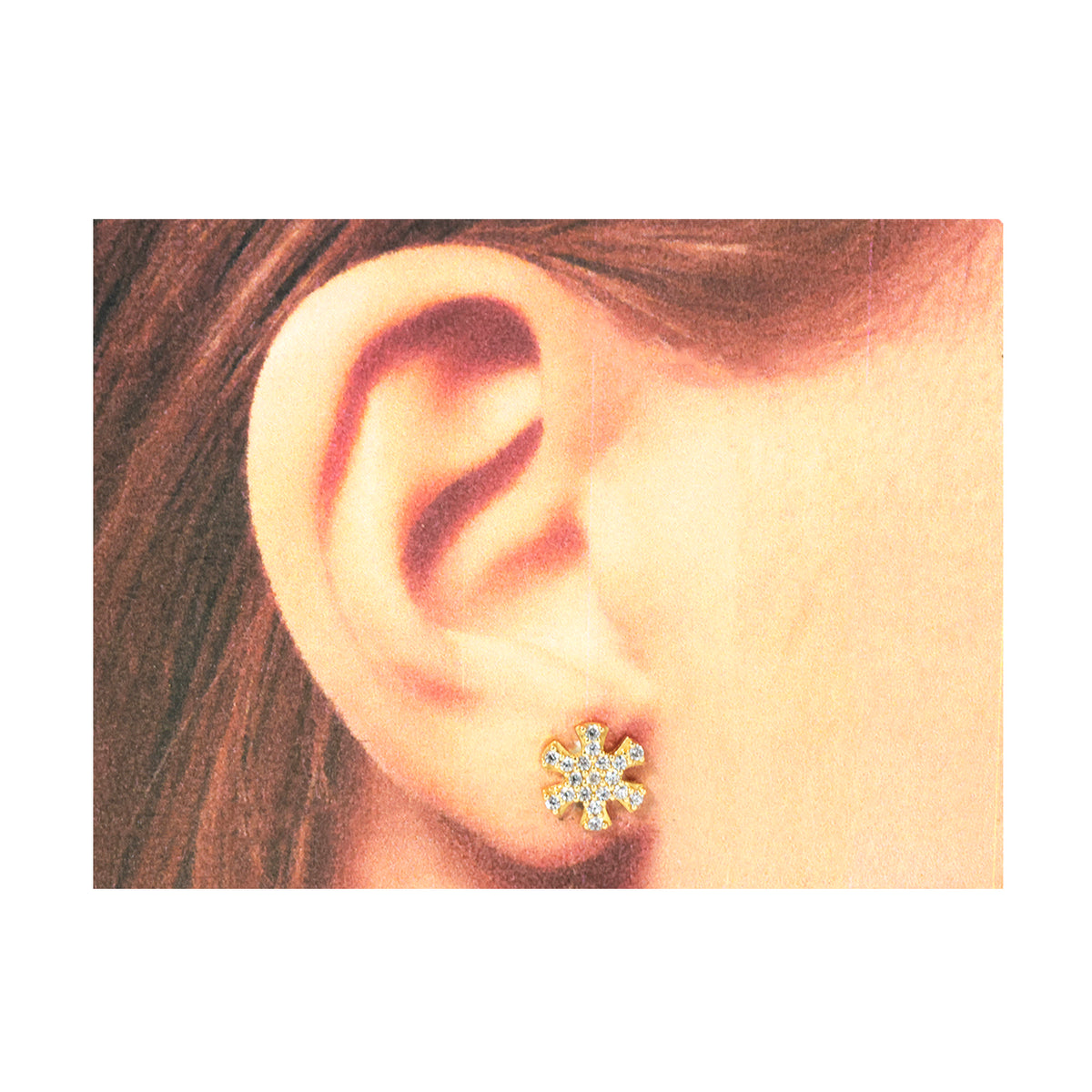 Close-up of an ear wearing a diamond stud earring with hair partially visible.