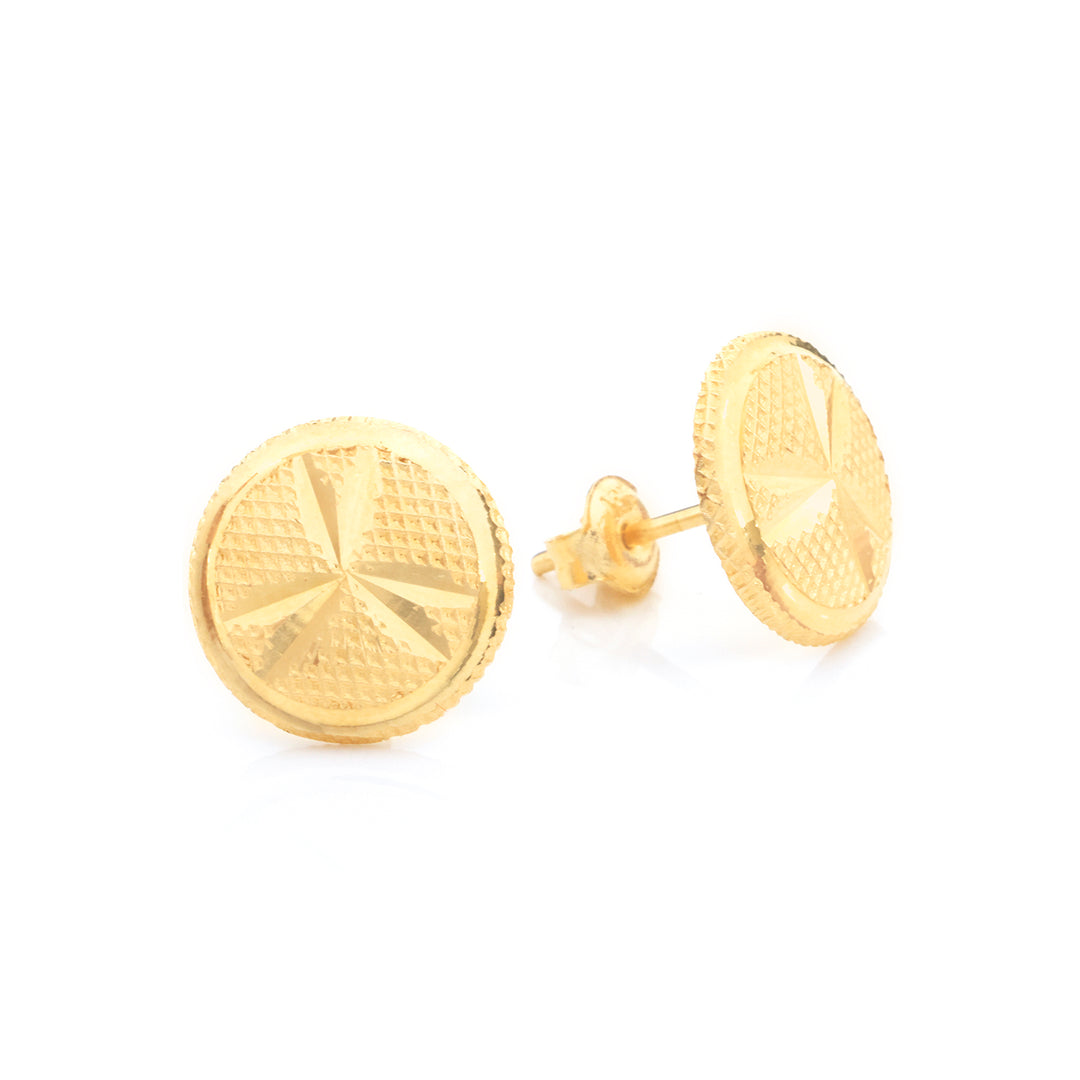 A pair of round gold stud earrings with a textured, geometric starburst pattern on the face and a beaded edge, shown on a clean white background.