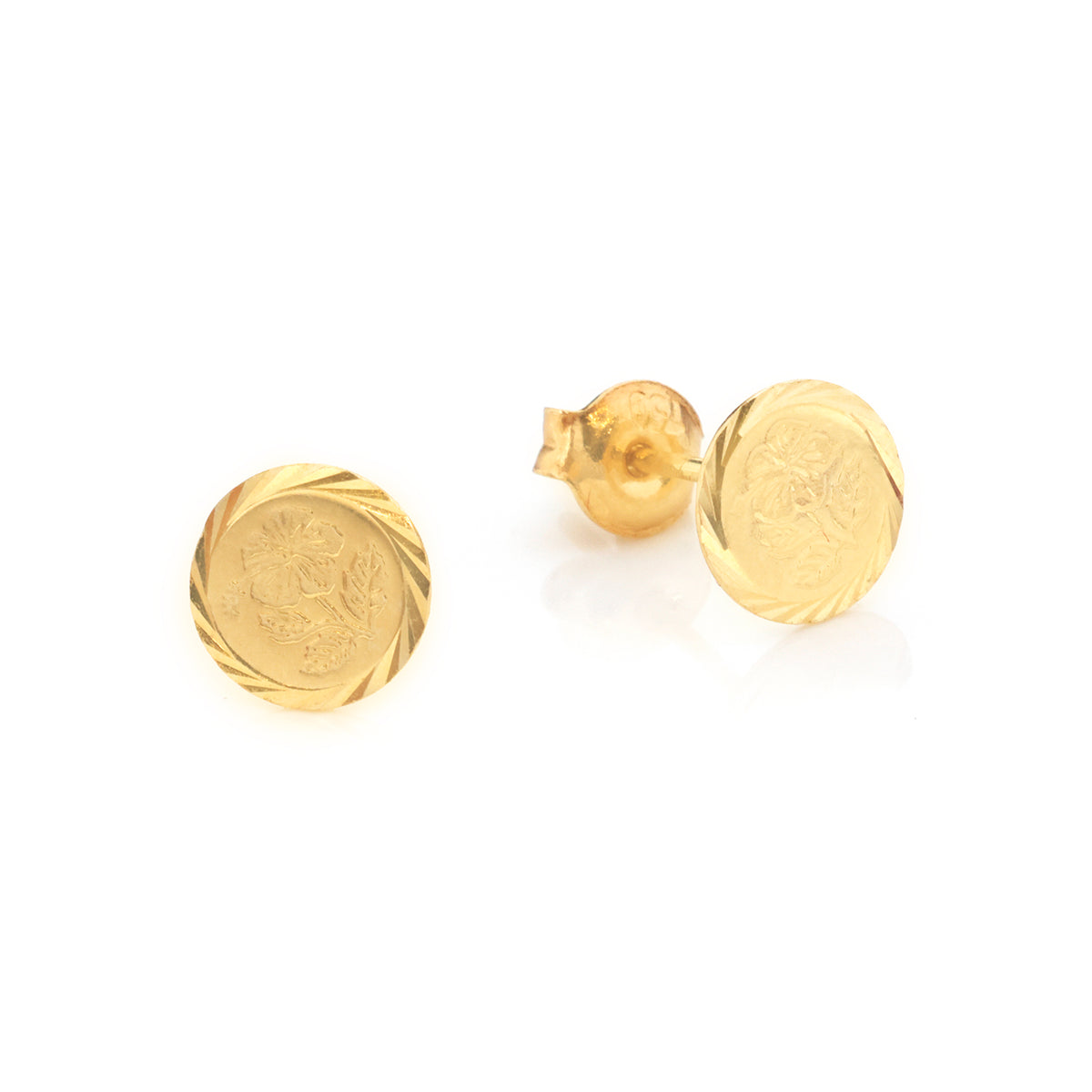 A pair of round gold stud earrings with a textured, medallion-like engraved face, shown on a clean white background.