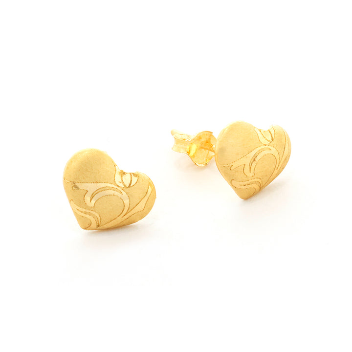 Gold heart-shaped earrings on a white background