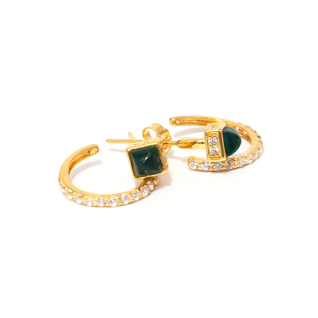 Gold hoop earrings with green gemstones and clear stones on a white background