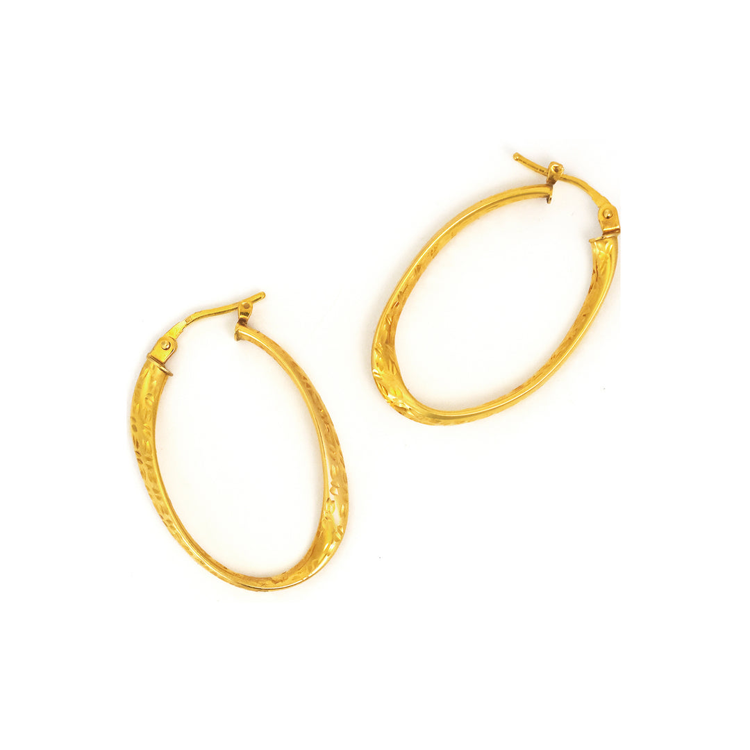 Gold hoop earrings on a white background