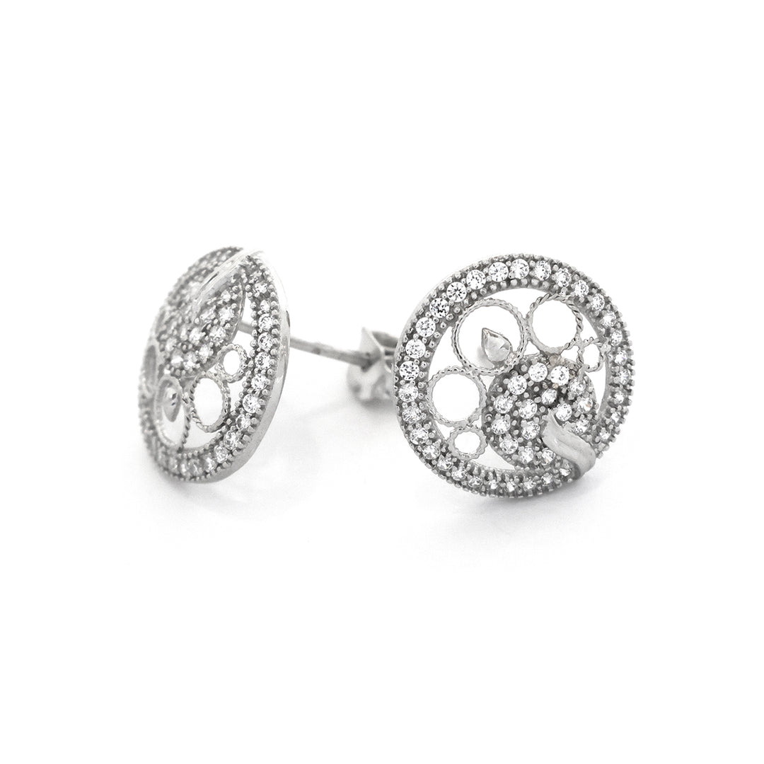 Silver earrings with intricate design on a white background