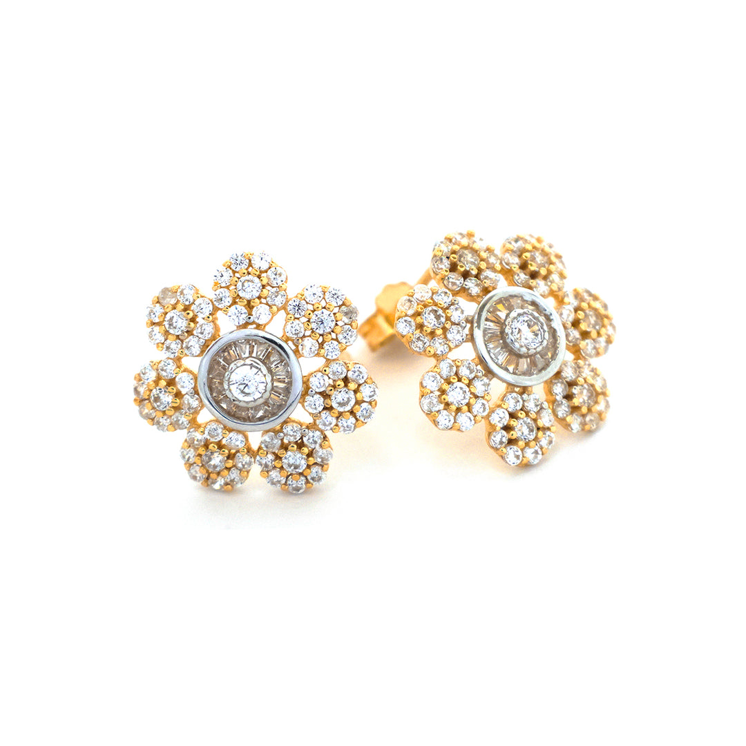 Gold and diamond earrings on a white background