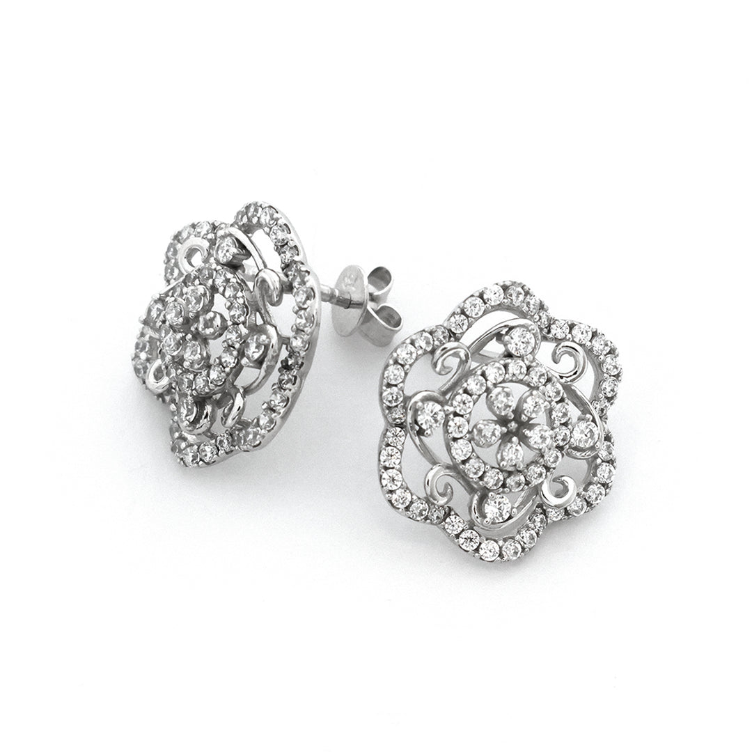 Heart-shaped silver earrings with intricate designs on a white background