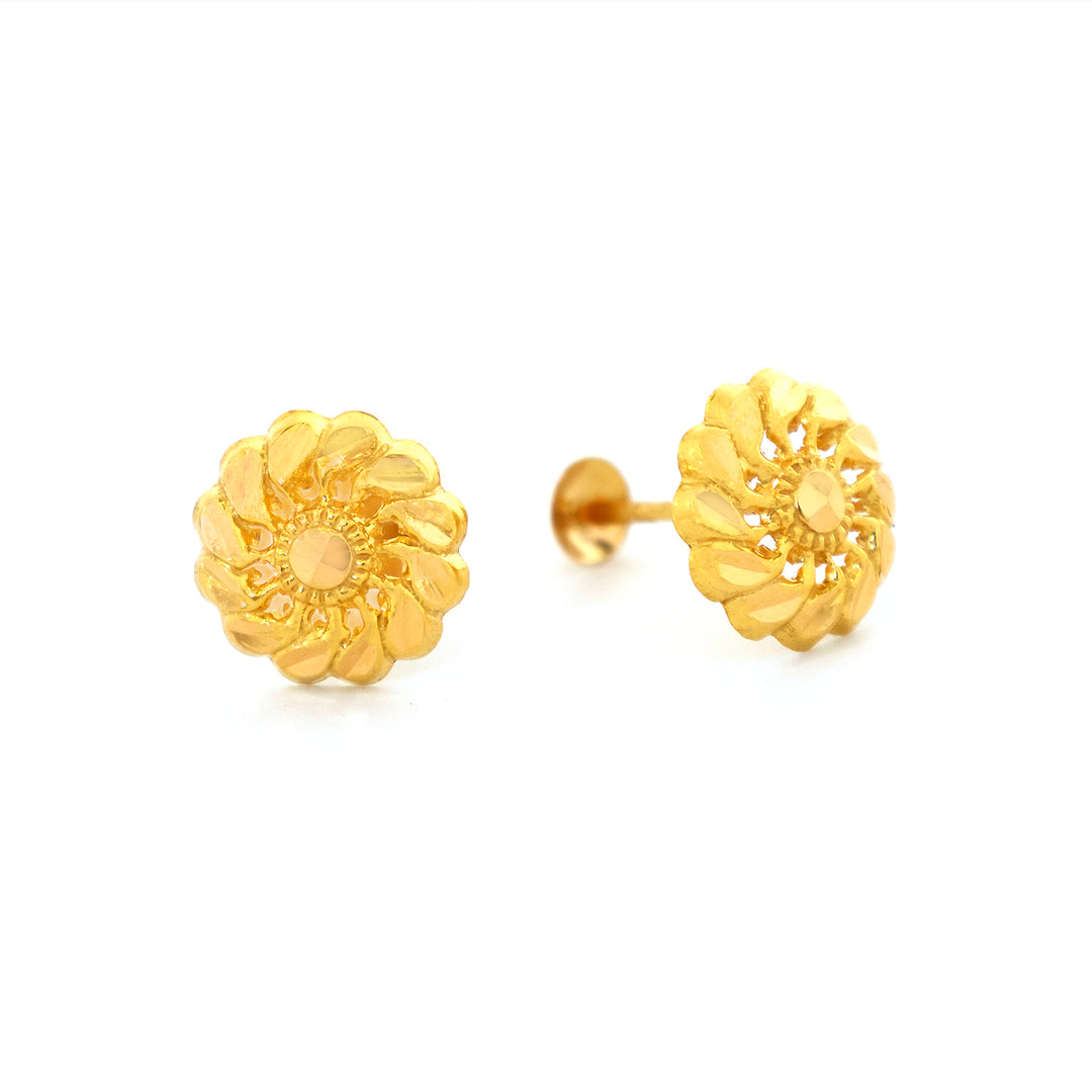 Pair of gold floral earrings on a white background
