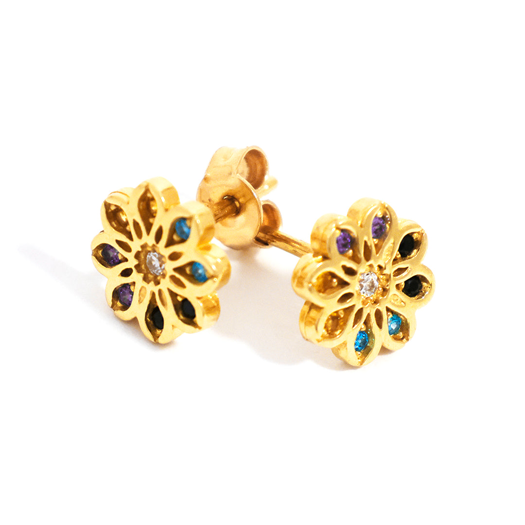 Gold flower-shaped earrings with gemstones on a white background