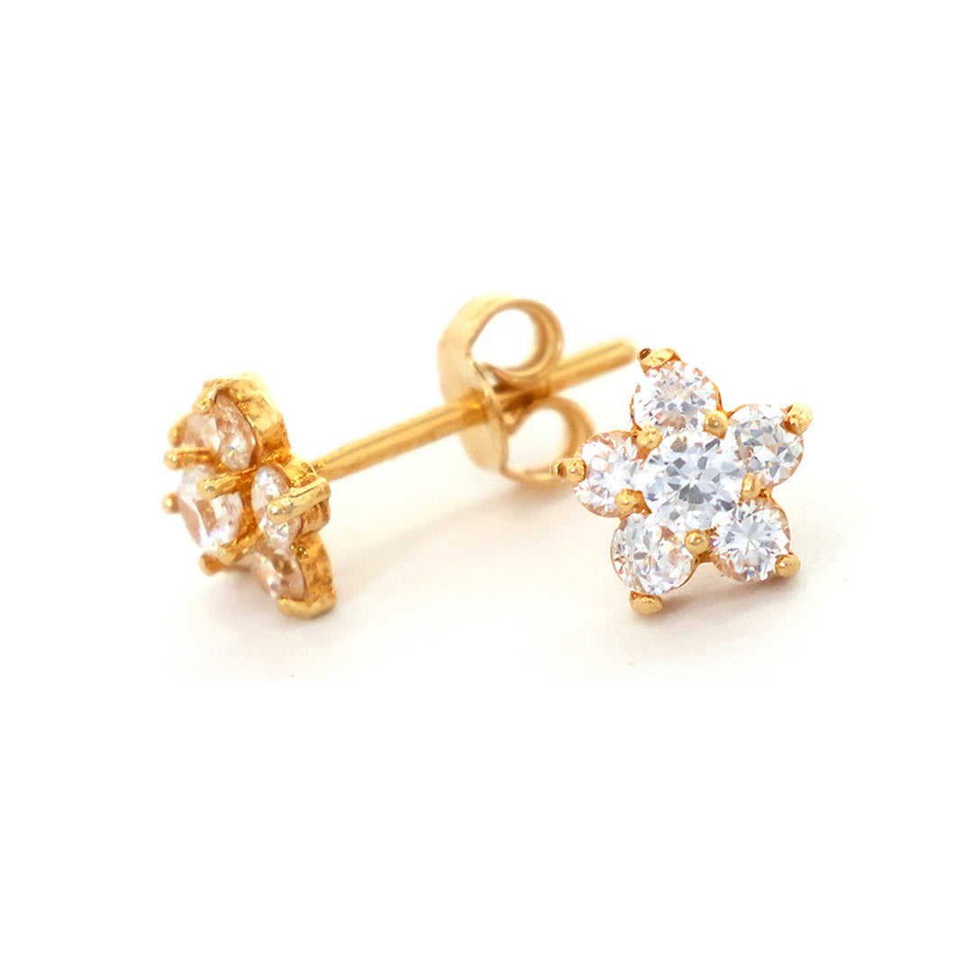 Gold earrings with clear gemstones on a white background