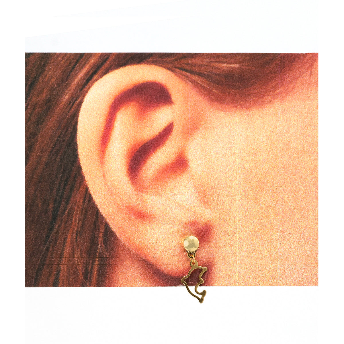 Close-up of an ear wearing a pearl earring with a gold fish charm.