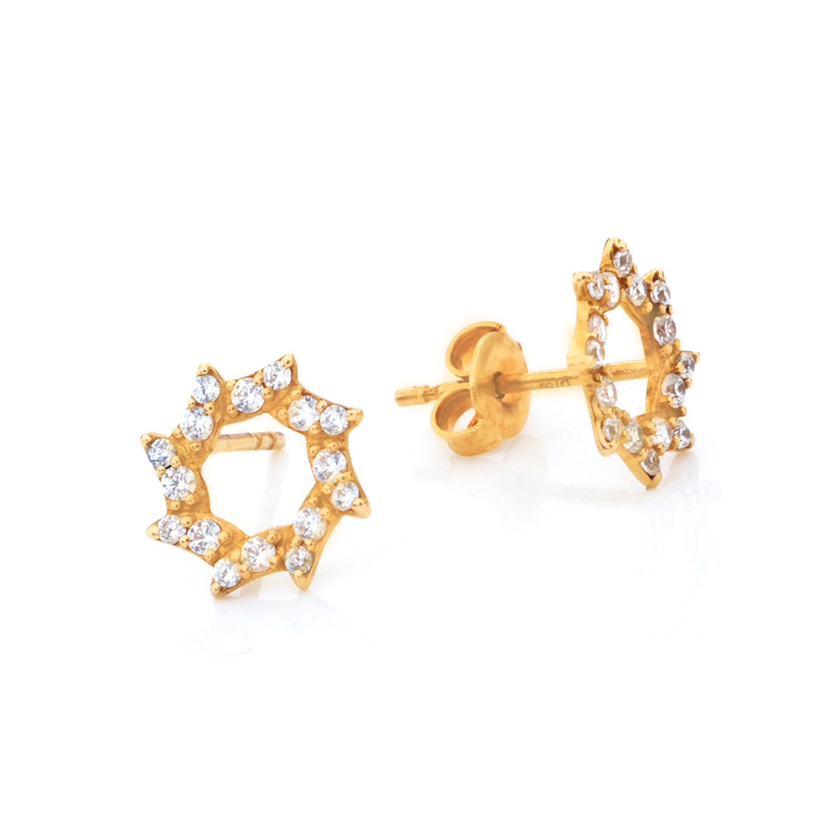 A pair of gold starburst stud earrings adorned with small clear cubic zirconia stones, shown on a clean white background.