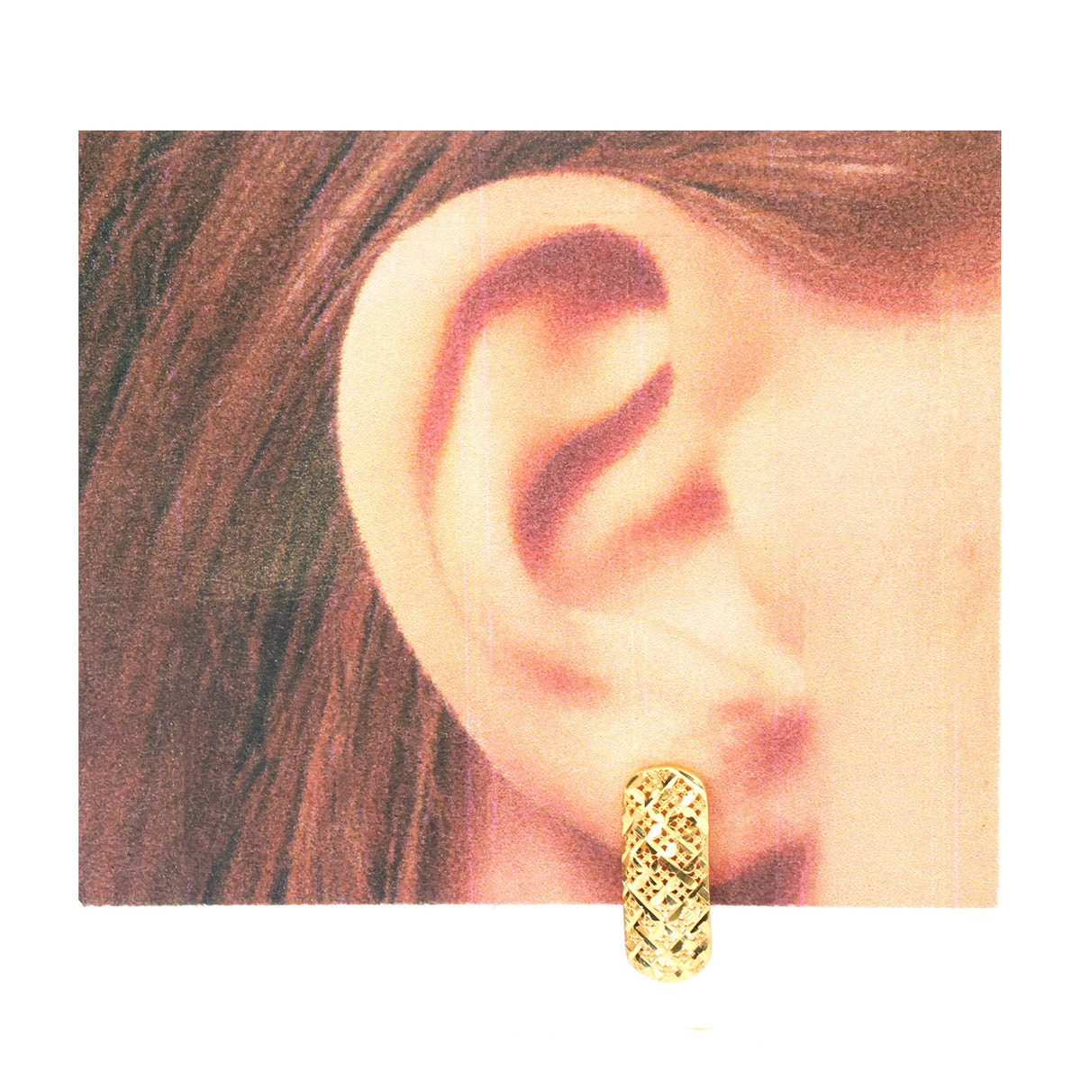 A close-up of a person's ear wearing a small gold hoop earring with a textured, woven or basket-like pattern.