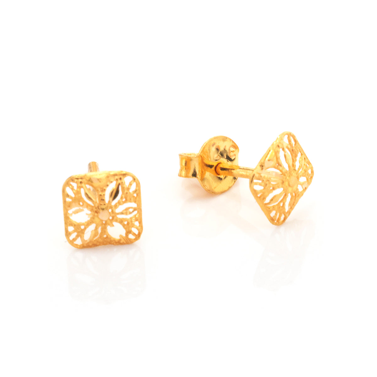 A pair of gold stud earrings with a square filigree cutout design, one shown from the front and the other from the side/back, on a white reflective background.
