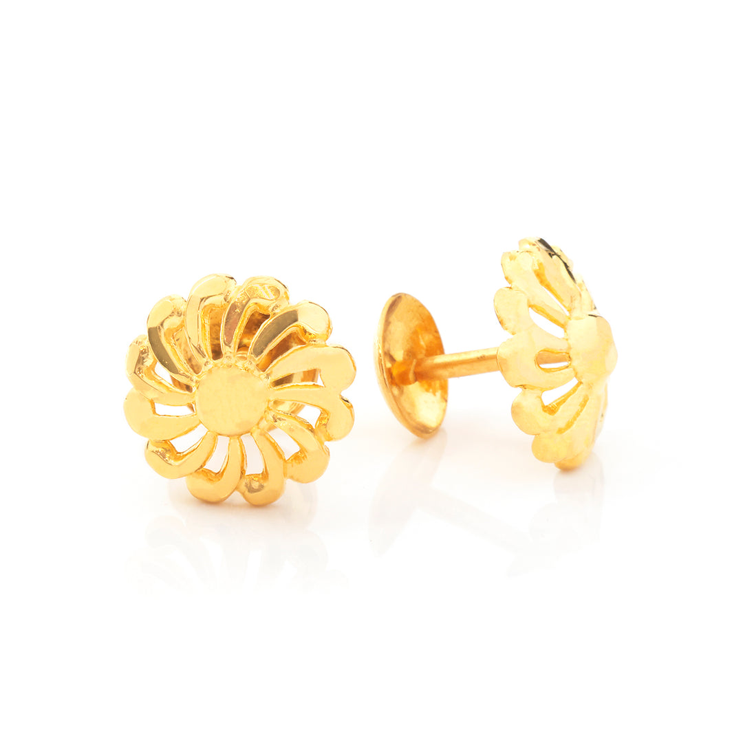 A pair of gold flower-shaped stud earrings, with one earring facing forward to show the petal design and the other turned sideways to show the post and backing, on a clean white background.