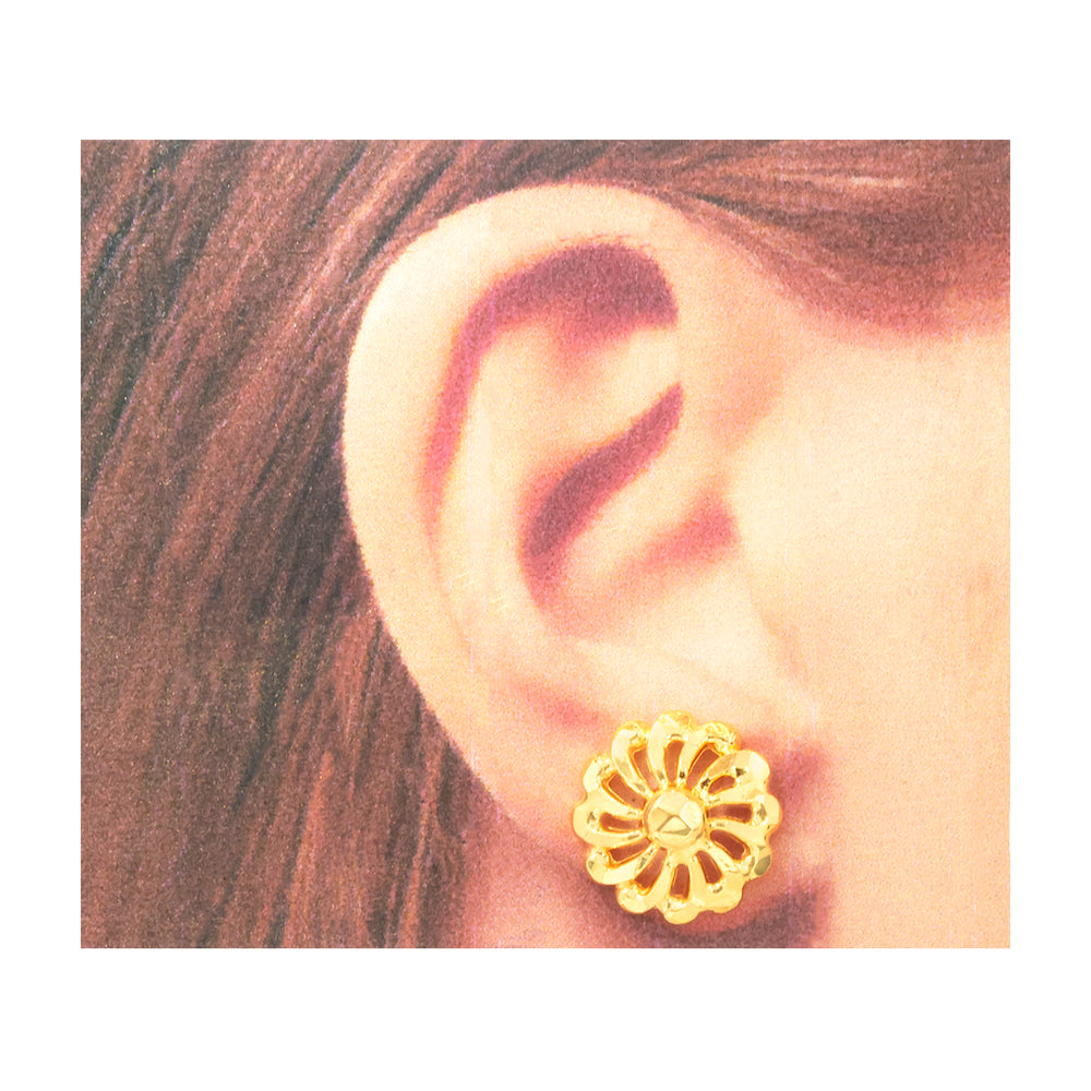 A close-up of a person's ear wearing a small gold flower-shaped stud earring.