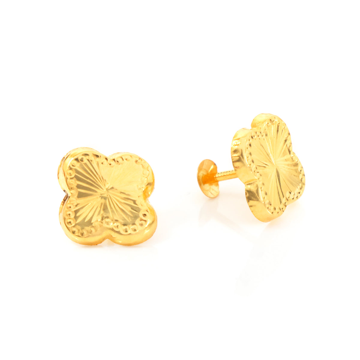 A pair of gold four-leaf clover stud earrings, one shown from the front with a textured sunburst pattern and the other from the side showing the post and backing, set against a plain white background.