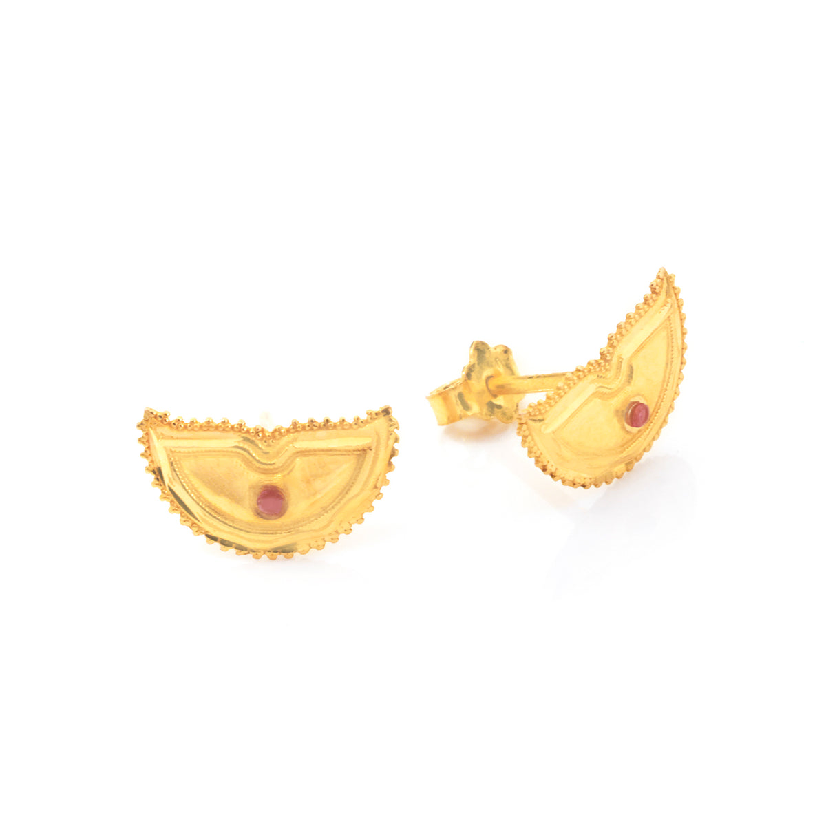 A pair of gold crescent-shaped stud earrings with a small round red gemstone in the center, shown on a plain white background.