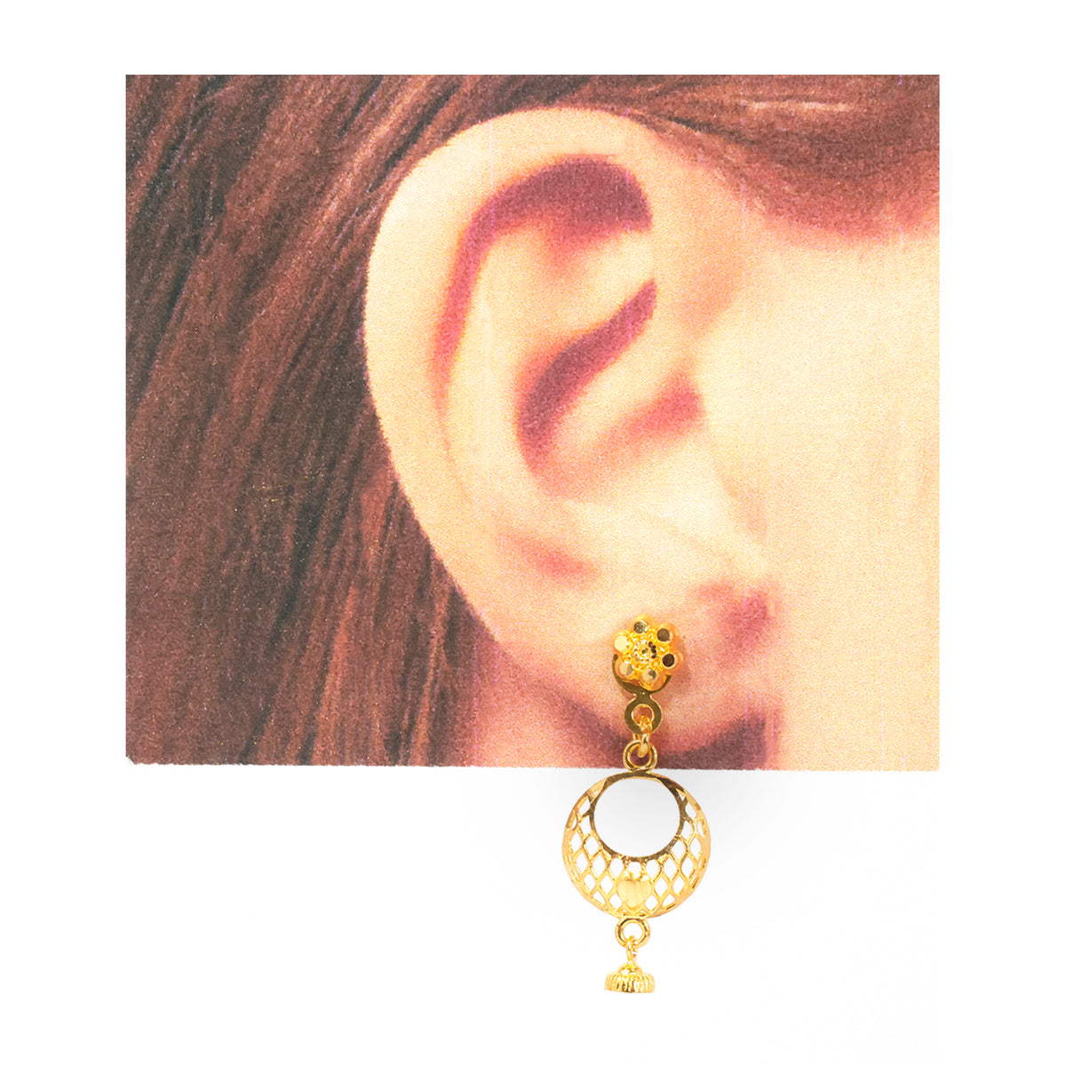 A gold-toned double drop earring worn on a person's ear, shown against a close-up background of the ear and hair with a white border around the image.