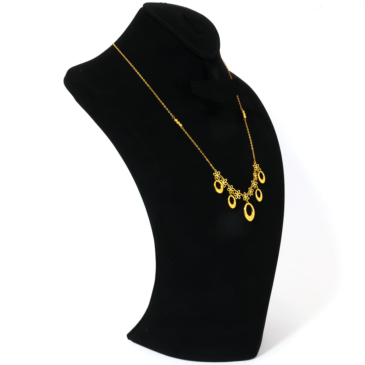 Gold necklace with a blue pendant on a black mannequin bust.