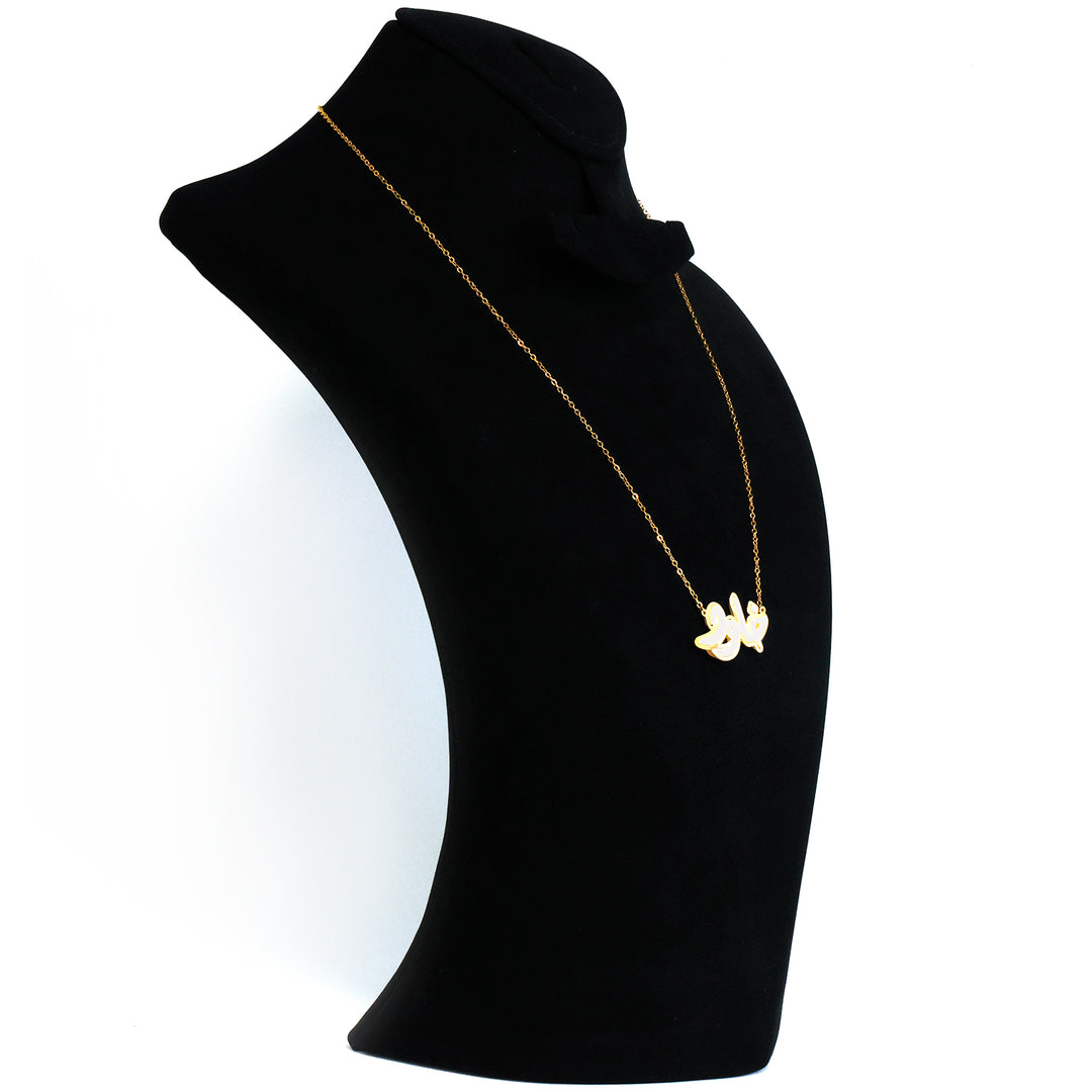 Gold necklace on a black mannequin bust against a white background