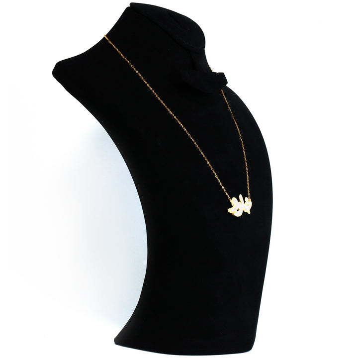 Gold necklace on a black mannequin bust against a white background
