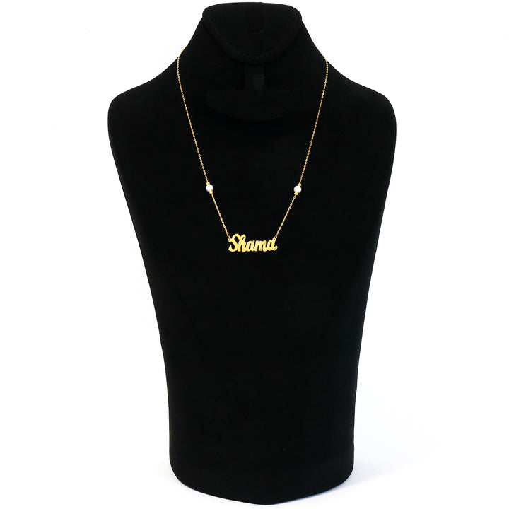 Gold necklace with 'Shama' pendant on a black mannequin bust.
