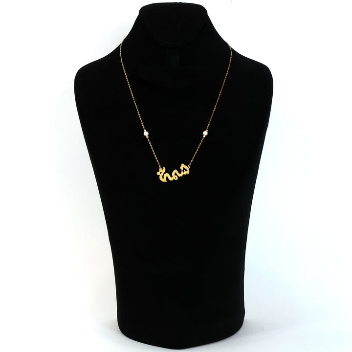 Gold necklace with a pendant on a black mannequin bust against a white background