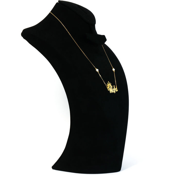 Black turtleneck sweater with a gold necklace on a white background