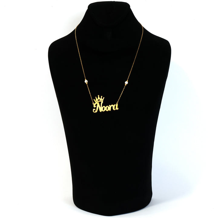Gold necklace with 'Noori' pendant on a black mannequin bust.