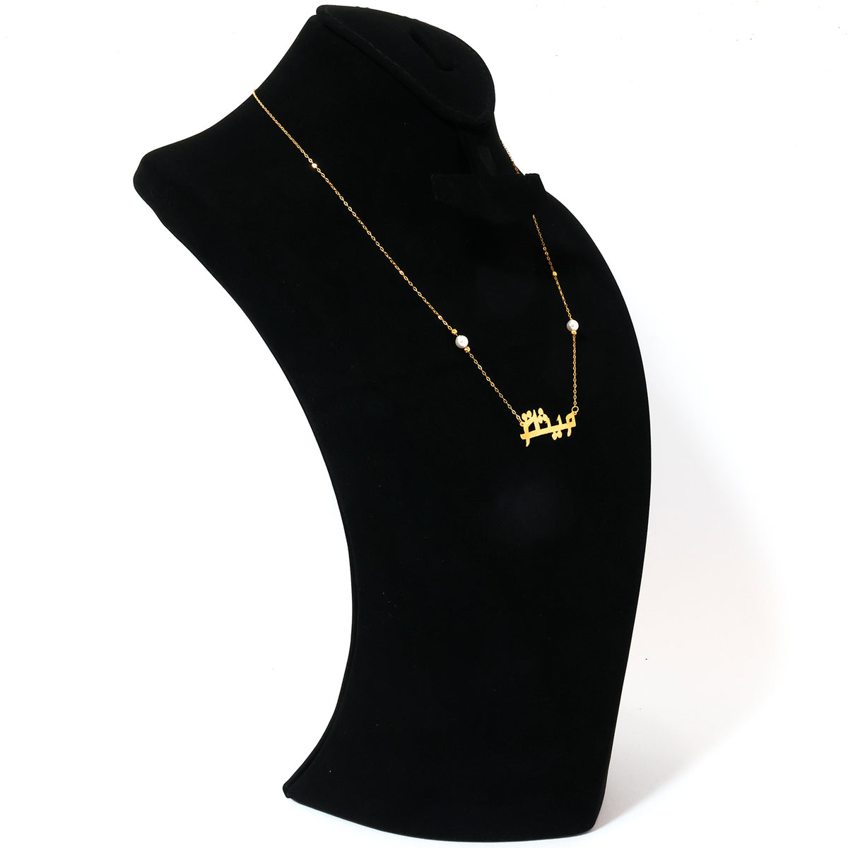 Pearl necklace on a black mannequin bust against a white background