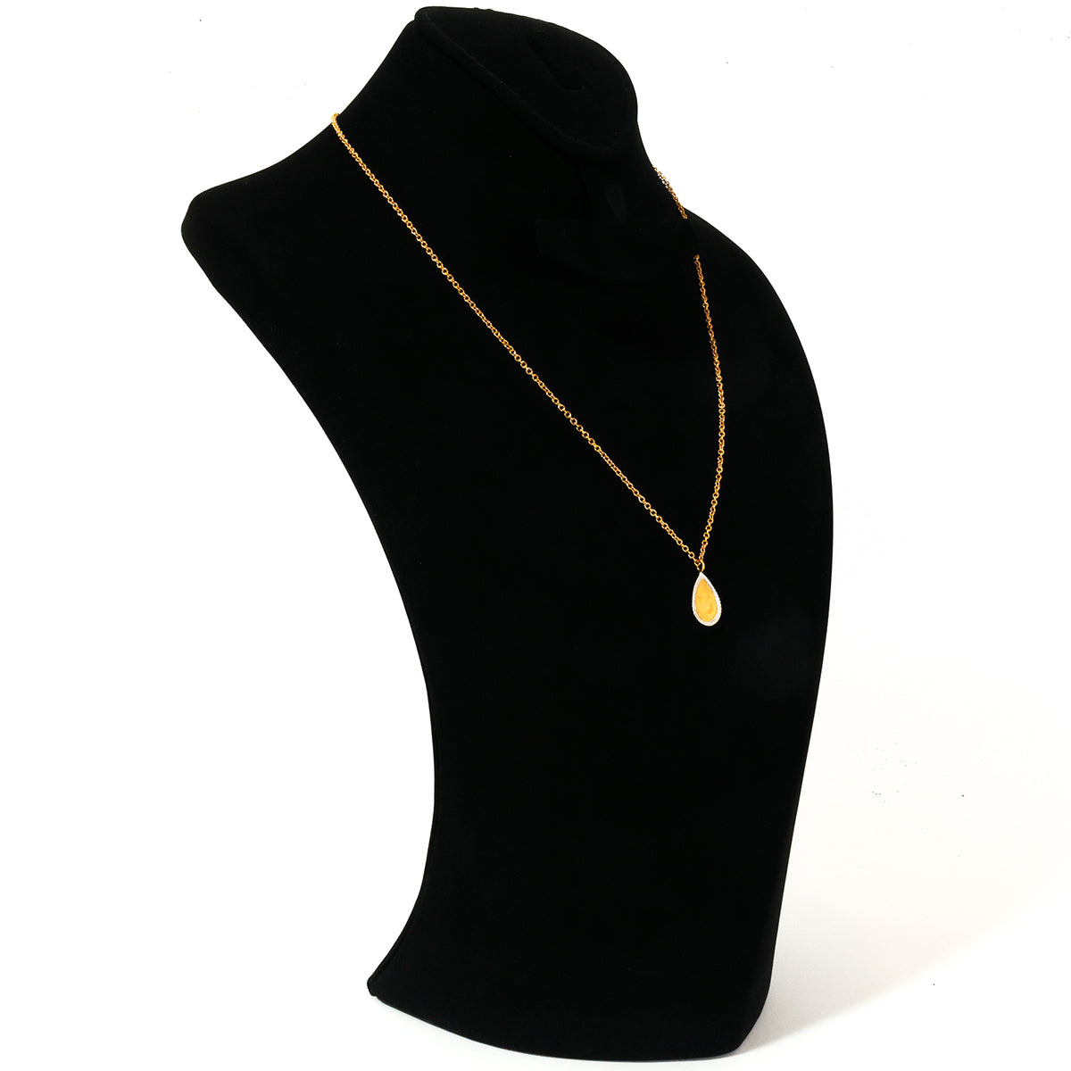 Gold necklace on a black mannequin bust with a white background