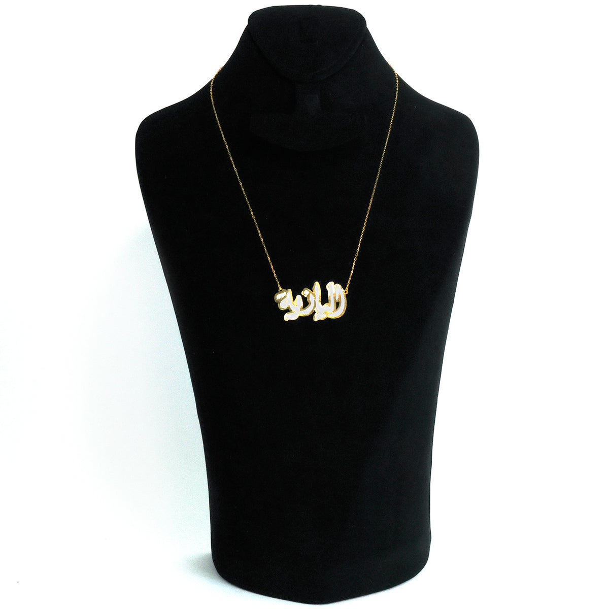 Necklace with a gold pendant on a black mannequin bust against a white background
