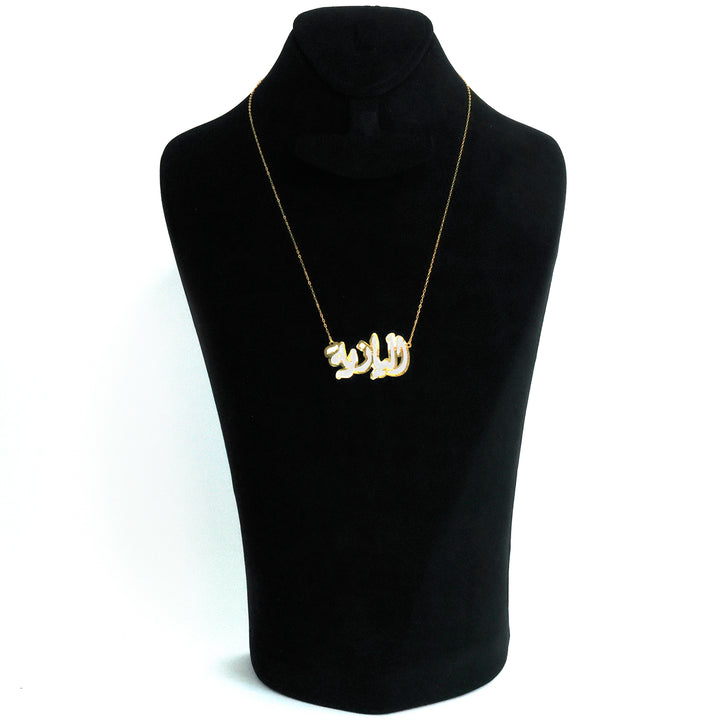 Necklace with a gold pendant on a black mannequin bust against a white background
