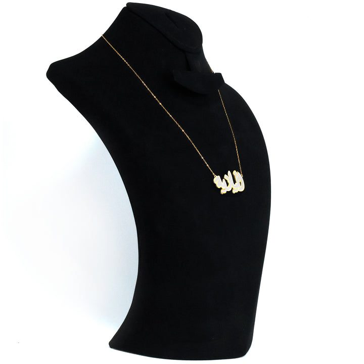 Black turtleneck sweater with a gold necklace on a white background