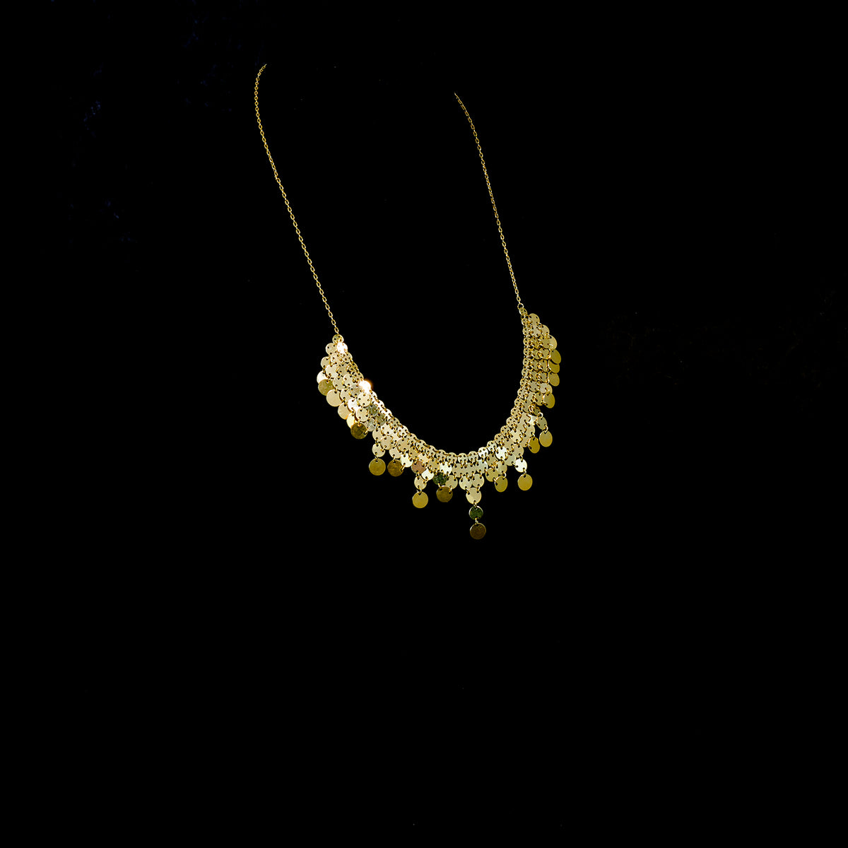 Gold necklace on a black background